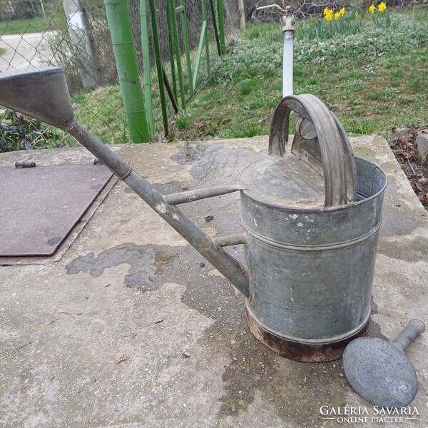 Old tin watering can with lid