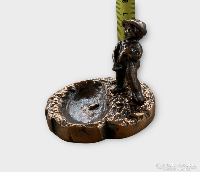 Old copper ring holder with a statue of a peeing boy