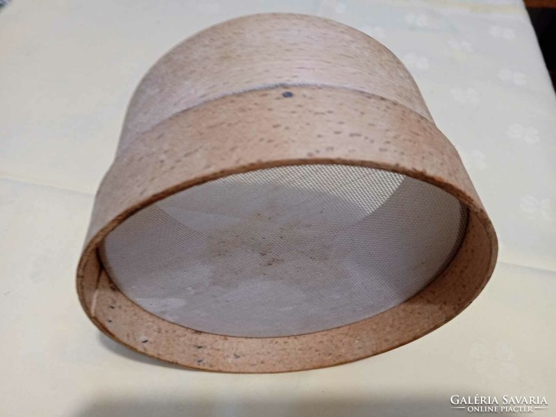 A small sieve or strainer with an old wooden frame