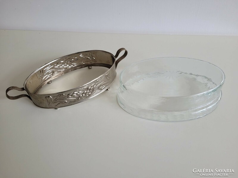 An old glass bowl in a metal holder
