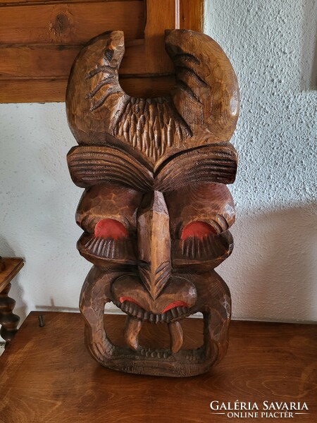 Large, relief wood carving, wall decoration in the form of a bus mask