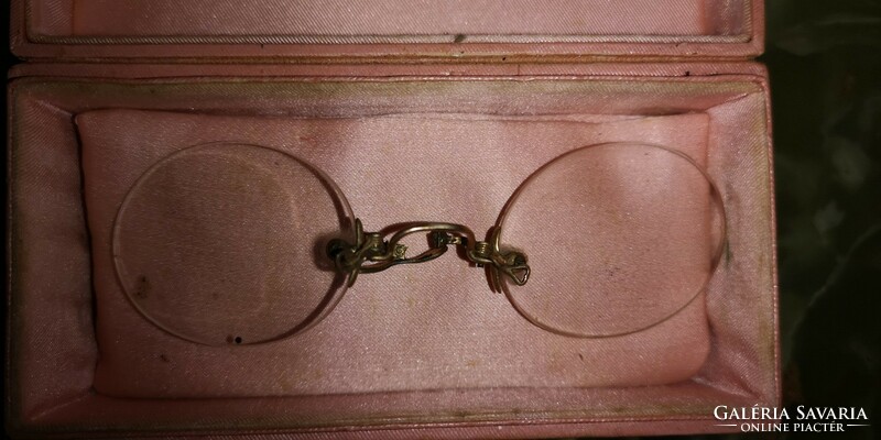 Antique glasses with gold nose part