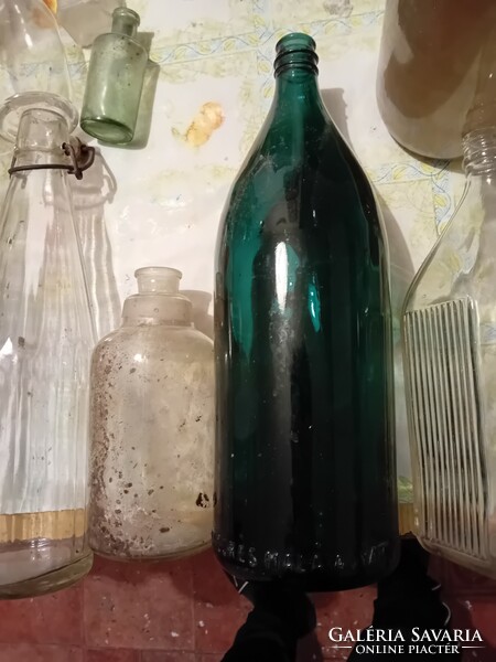 A collection of bottles and soda with inscriptions