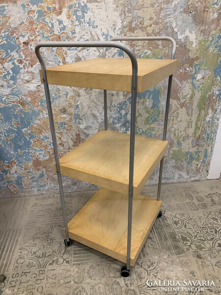 Modern folding trolley made of thick furniture board with a wood grain pattern, on a metal frame, with castors.