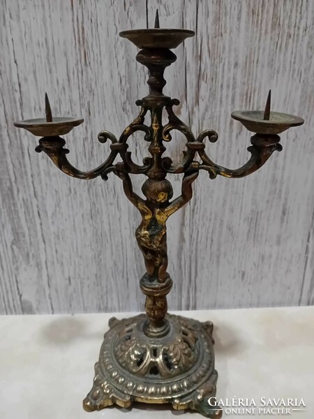 Three-pronged copper candle holder with putto