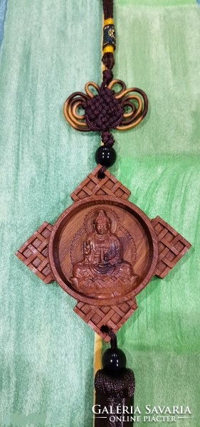 Real room. Rosewood pendant, amulet, buddha