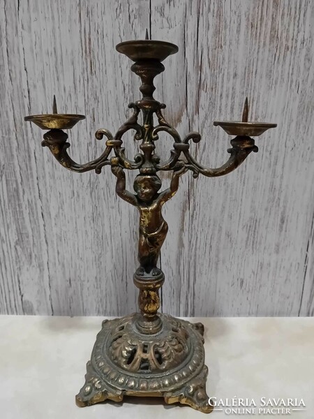 Three-pronged copper candle holder with putto