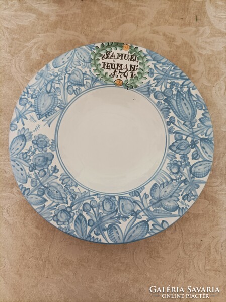A pair of large ceramic wall plates, they are not identical