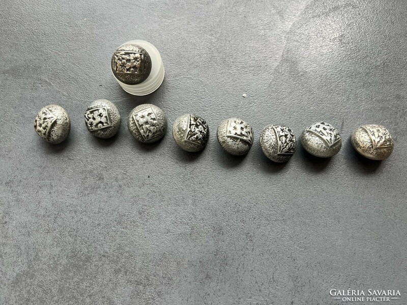 Old metal buttons with a pattern of mountain grass