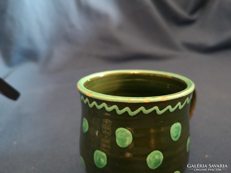 Glazed ceramic mug decorated with old folk motifs