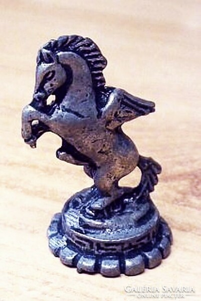 Antique miniature lead figure. A stallion with a crown