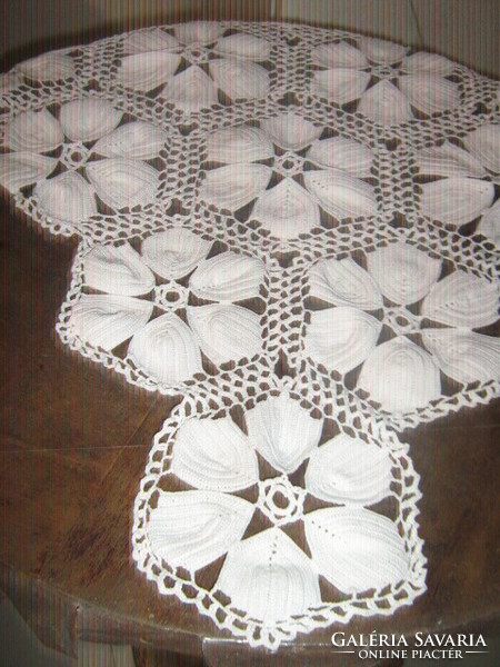 Beautiful white hand-crocheted boat-shaped lace tablecloth with floral pattern