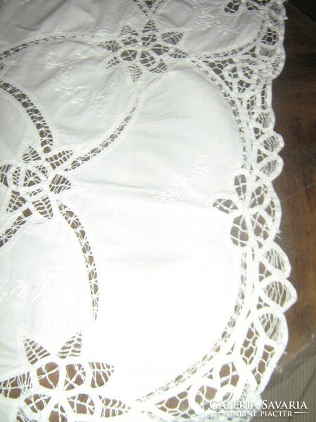 Beautiful ribbon embroidered on white lace tablecloth