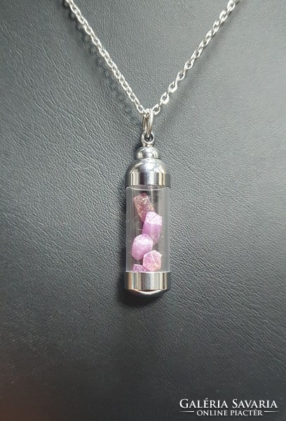 Pendant with aquamarine and ruby gems.