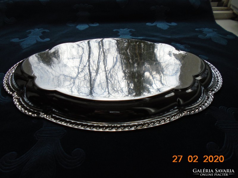 Chrome-nickel metal tray with a baroque shape, embossed rim, and chiseled antique patterns
