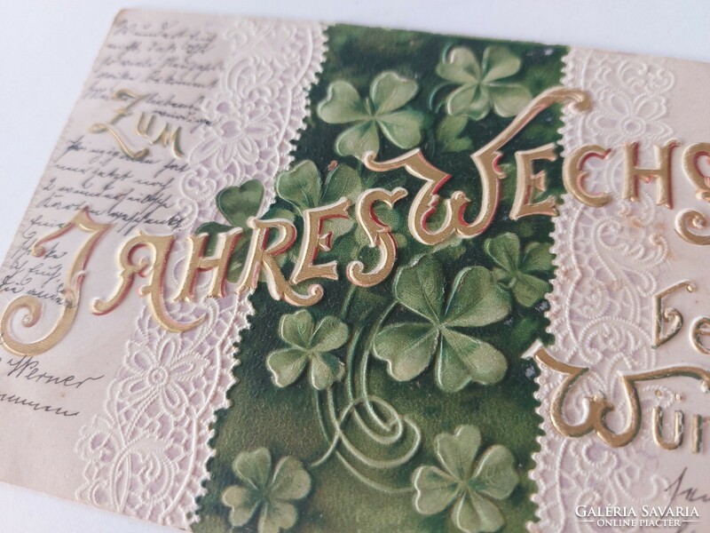 Old embossed postcard with clover lace