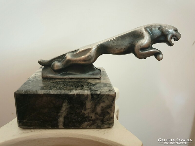 Jaguar logo metal statue on a marble plinth