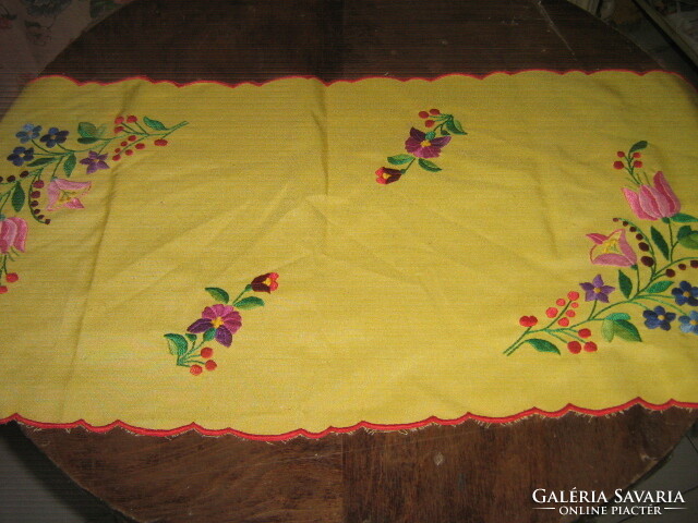 Runner of Kalocsa embroidered tablecloth on a beautiful yellow background