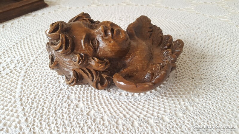 Beautiful angel head carved from old wood