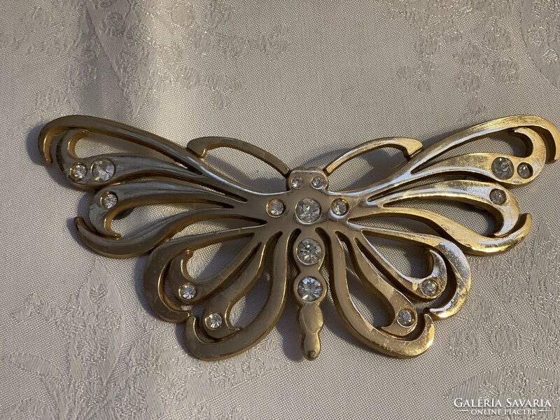 Large metal butterfly decorated with stones.