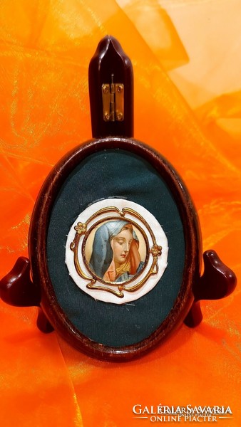 Madonna picture in an old oval frame.