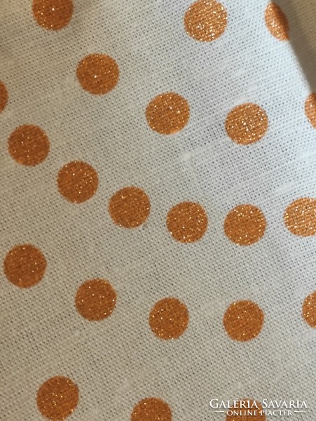 A huge, strong linen tablecloth waiting to be sewn, a do-it-yourself, shiny, polka dot, cheerful spring atmosphere