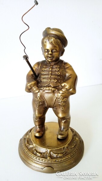 Bronze statue of a boy with a whip