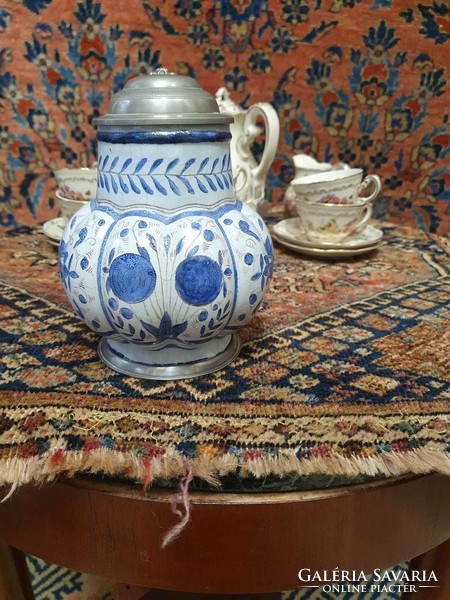 A faience jug marked with a 3-pronged crown coat of arms. 18 cm high. In very nice condition. Is it the end of 19.Sz?