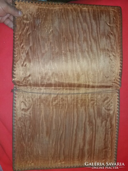 A leather folder laced along the relief side of an antique ship for 3 documents as shown in the pictures