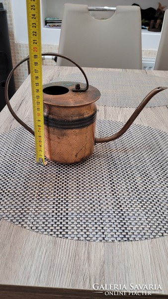 Handmade antique red copper watering can.