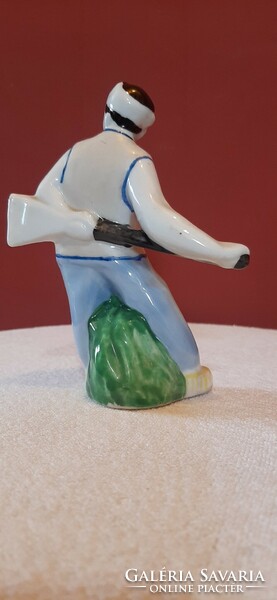 Porcelain statue. Boy with broom. Hand painted, marked 14 cm tall statue. Presumably North Korean.