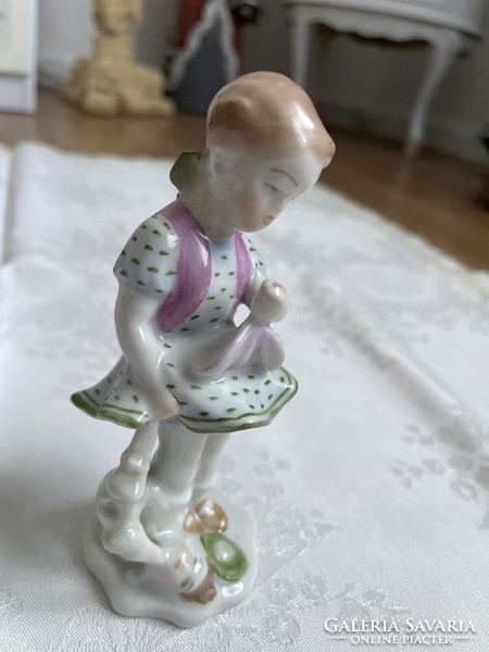 A little girl from Herend painted beautifully with her doll.