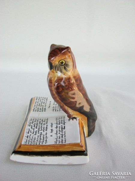 Owl sitting on a ceramic book in Bodrogkeresztúr