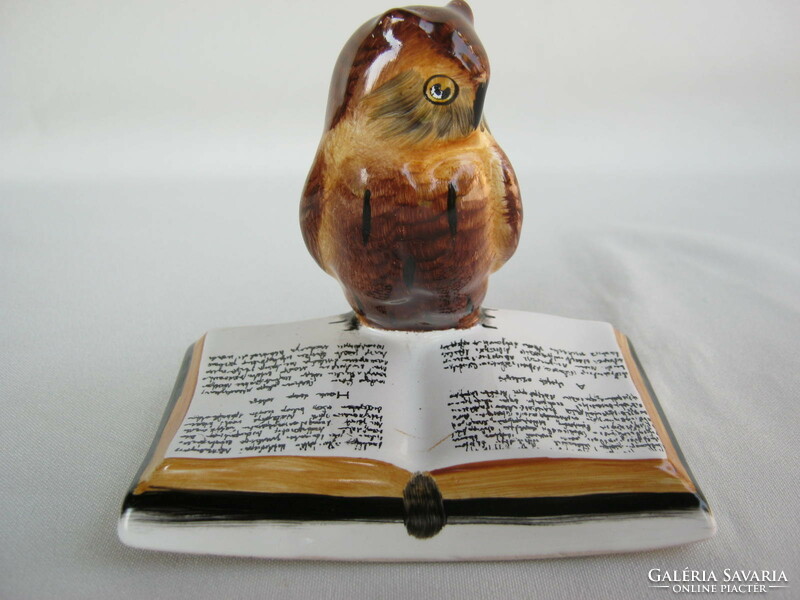 Owl sitting on a ceramic book in Bodrogkeresztúr