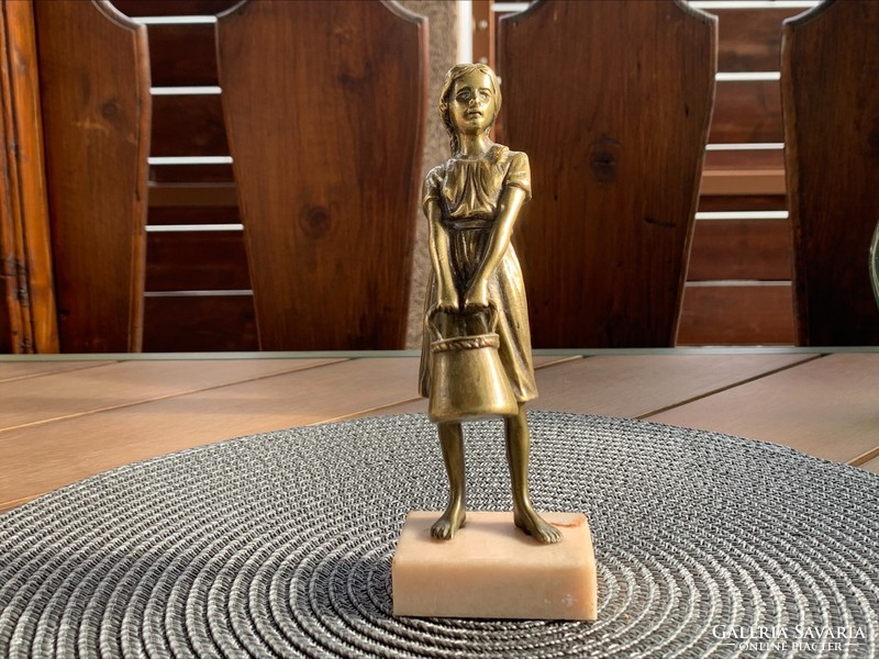 Bronze statue of a girl carrying water on a marble base