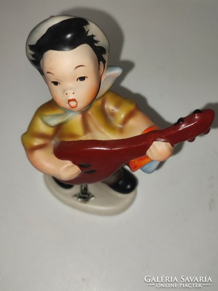 Rare West German cortendorf figure of a boy with a guitar.