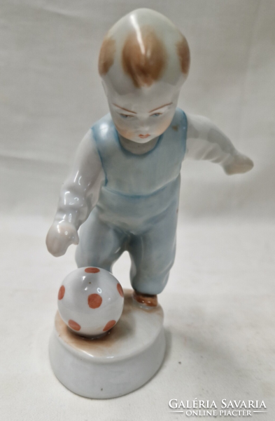 A porcelain figure of a boy playing a ball, designed by András Zsolnay Sinkó, in perfect condition