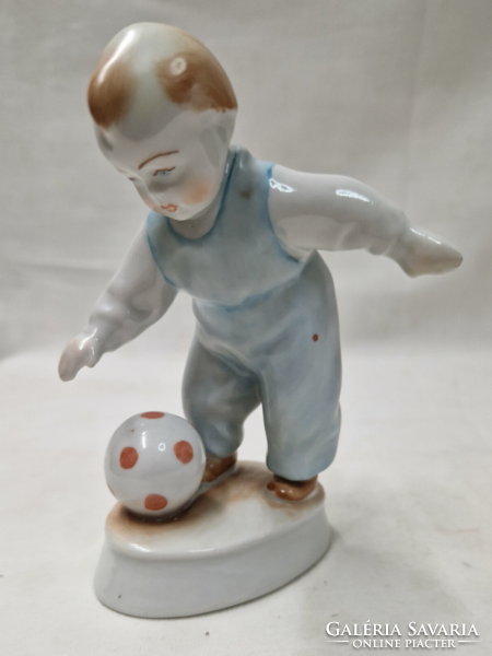 A porcelain figure of a boy playing a ball, designed by András Zsolnay Sinkó, in perfect condition