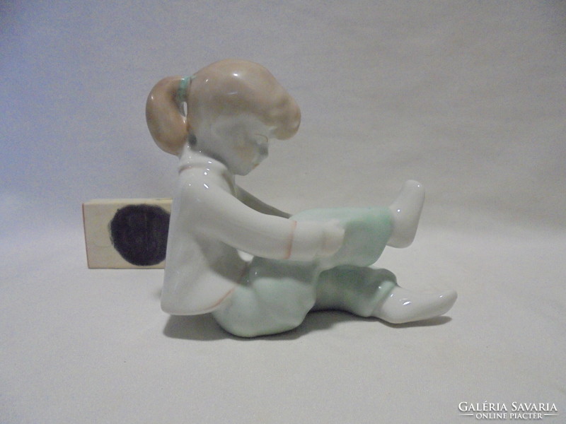 Aquincum porcelain figure of a girl tying her shoes, nipp