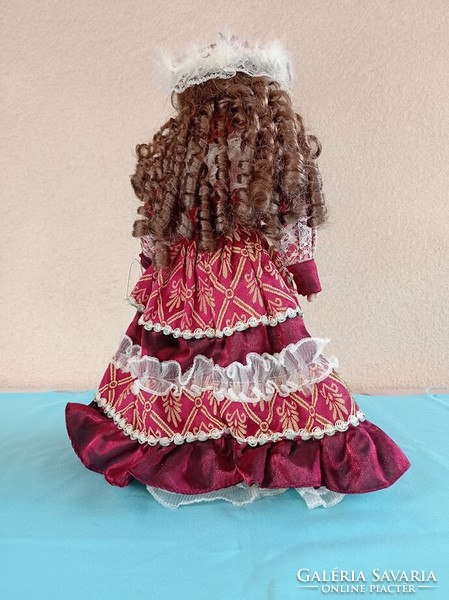 Doll with porcelain head on stand 40 cm