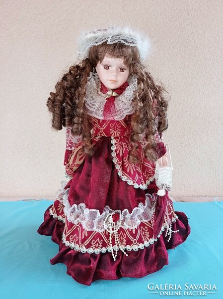 Doll with porcelain head on stand 40 cm