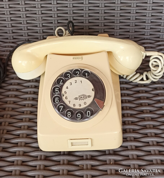 Cream-colored desk phone with extension cord