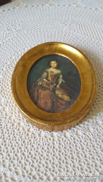 Beautiful gilded female portrait in an oval frame