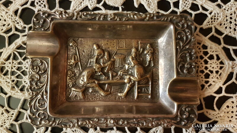 A life-size copper ashtray with a village scene in a patina condition with a beautiful engraving has been sold.