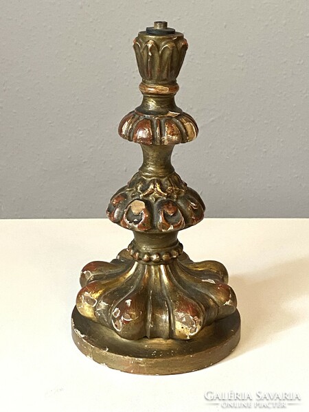 A table lamp in the baroque style, carved in cream maroon, gilded, marked antique
