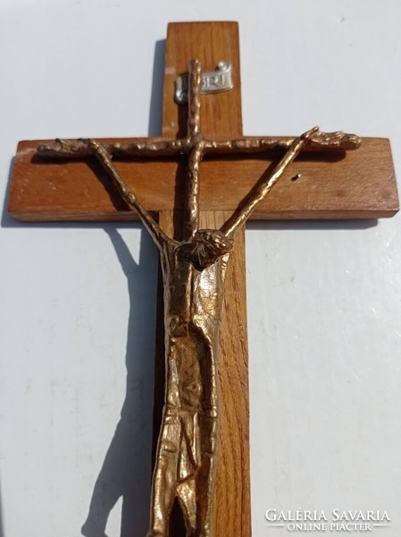 Bronze crucifix marked by Erwin Huber on a wooden home altar, 1983.