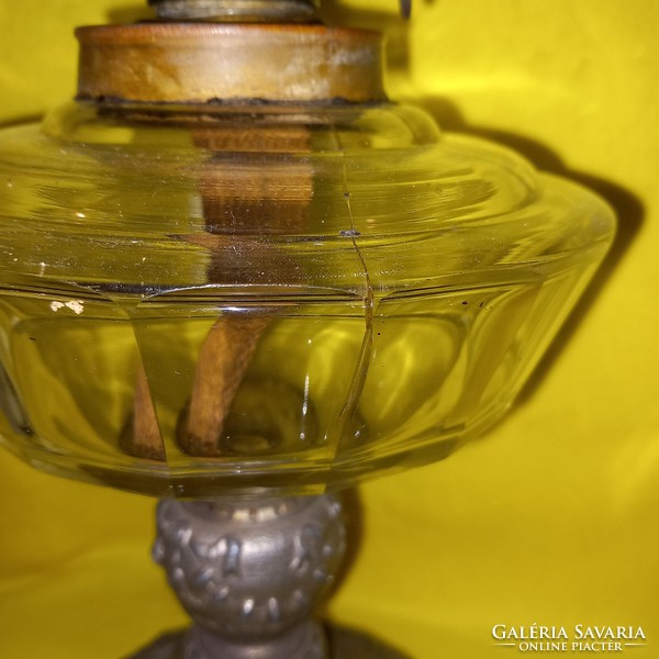 Old table kerosene lamp, metal base, glass container.