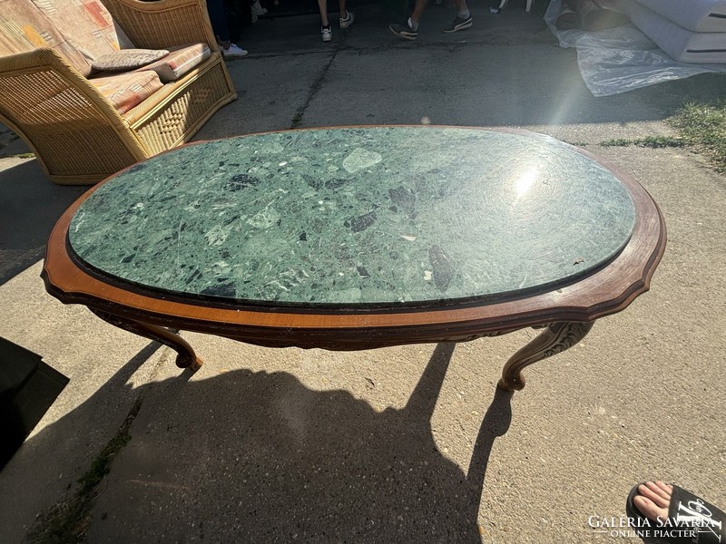 Coffee table with carved legs with a marble top