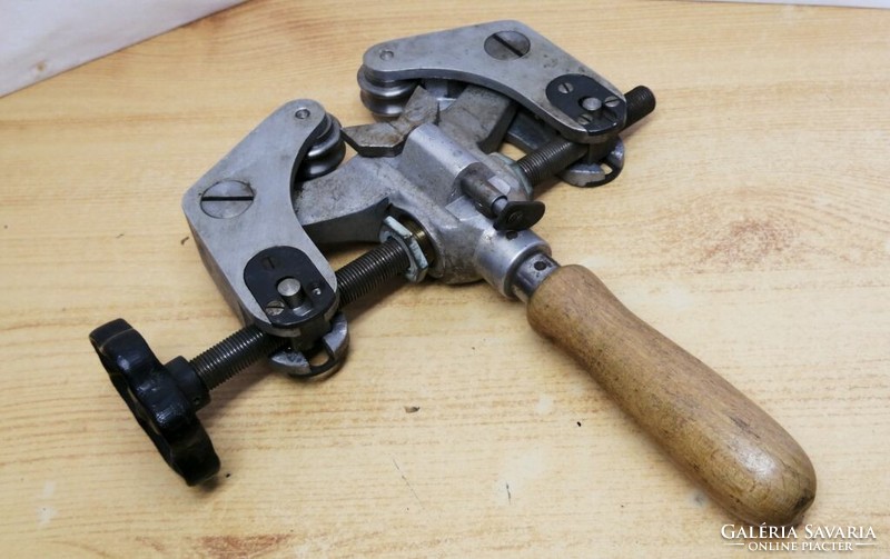 An old hand tool, probably a pipe or wire bender, for fine industrial work.