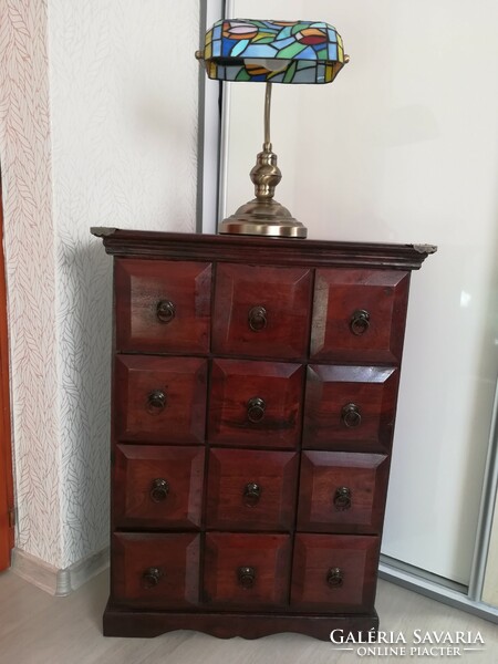 Colonial-style, exotic wooden dresser with 12 drawers. Brown color with a mahogany shade.